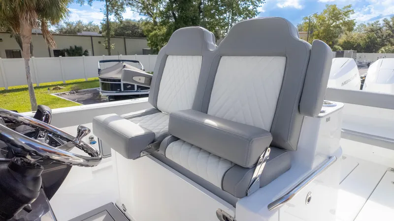 Slide: The Image of 2025 Everglades 315 Center Console boat seats, featuring gray and white upholstery. - 24