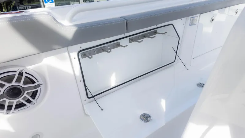 Slide: The Image of 2025 Everglades 315 Center Console boat interior with rod holders and speaker. - 25