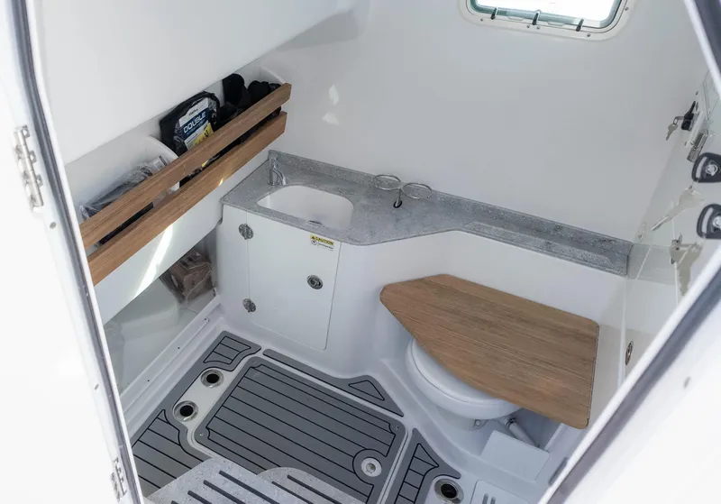 Slide: The Image of 2025 Everglades 315 Center Console boat interior with sink and toilet. - 26
