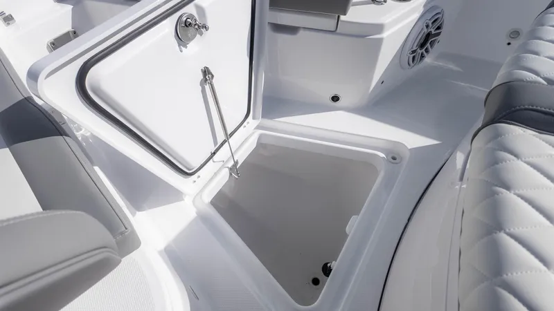 Slide: The Image of 2025 Everglades 315 Center Console boat storage compartment, open hatch, white interior. - 34