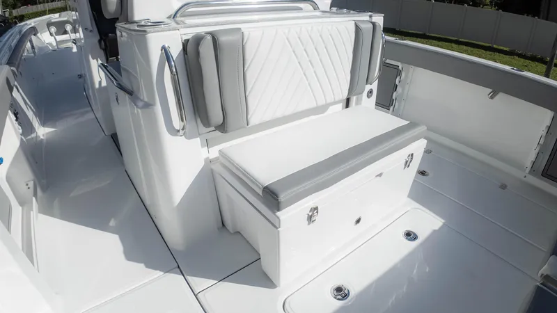 Slide: The Image of 2025 Everglades 315 Center Console boat interior with cushioned seating and storage. - 37