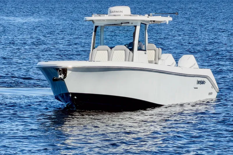 Slide: The Image of 2025 Everglades 315 Center Console boat on calm blue water. - 38