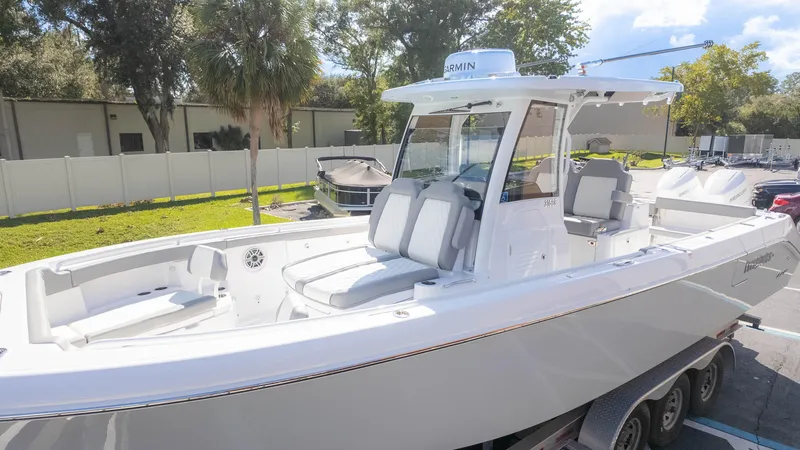 Slide: The Image of 2025 Everglades 315 Center Console boat on trailer, sleek design, outdoor setting. - 4