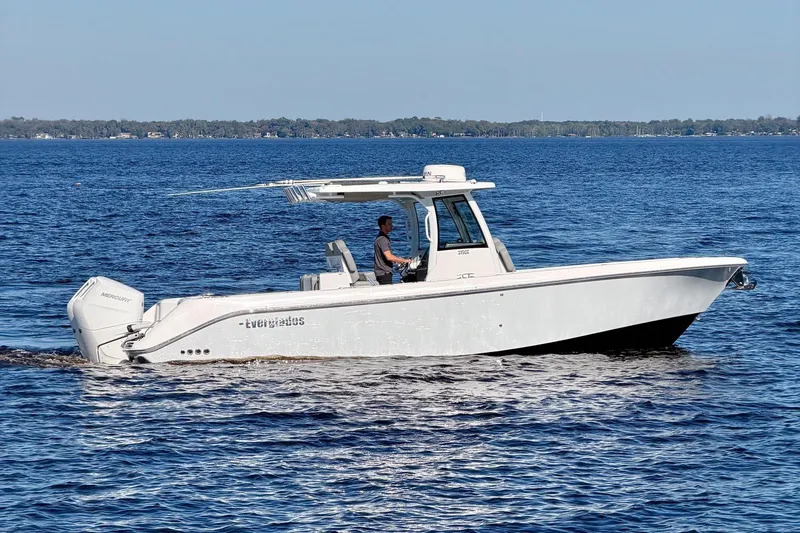 Slide: The Image of 2025 Everglades 315 Center Console boat cruising on open water. - 41
