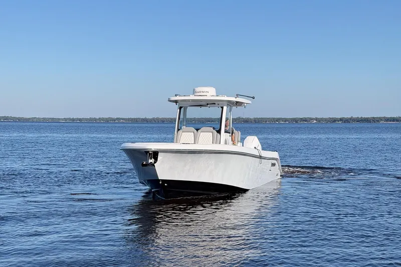 Slide: The Image of 2025 Everglades 315 Center Console boat cruising on calm blue waters. - 43