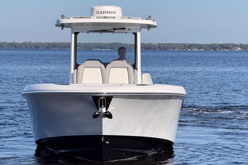 Slide: The Image of 2025 Everglades 315 Center Console boat cruising on a calm lake. - 44