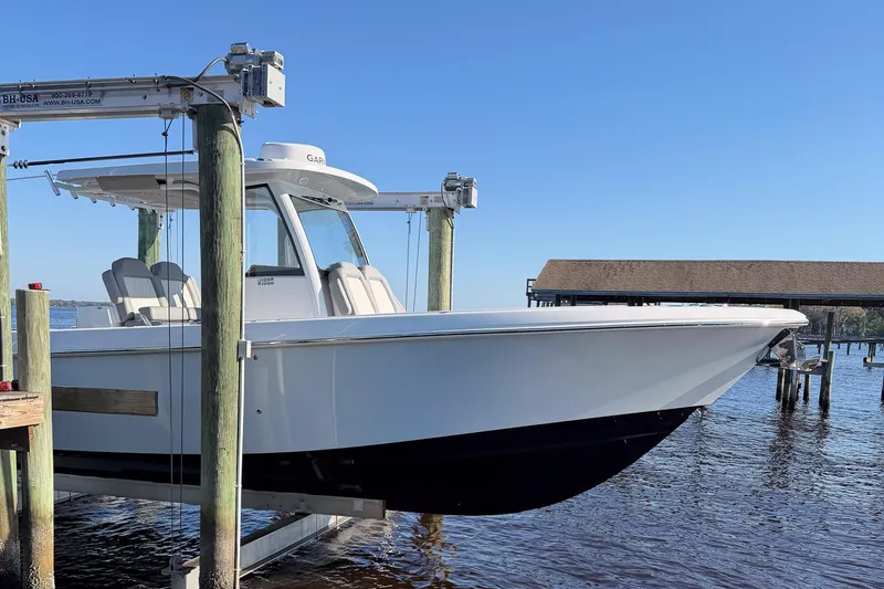 Slide: The Image of 2025 Everglades 315 Center Console boat on lift by waterfront dock. - 45