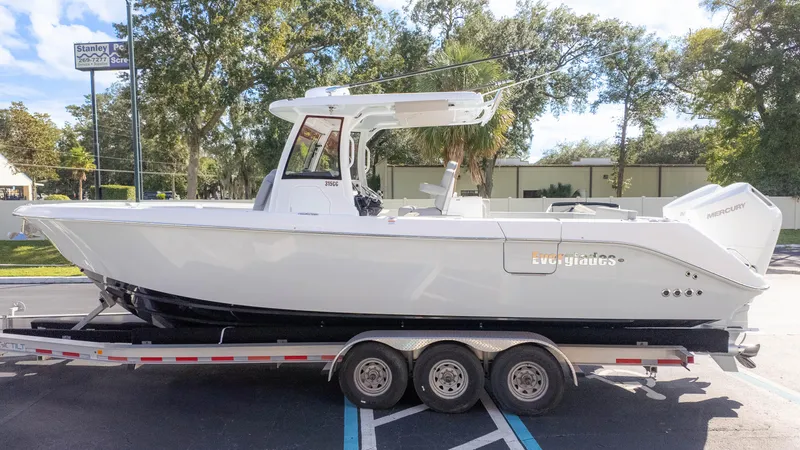 Slide: The Image of 2025 Everglades 315 Center Console boat on trailer, parked outdoors. - 5