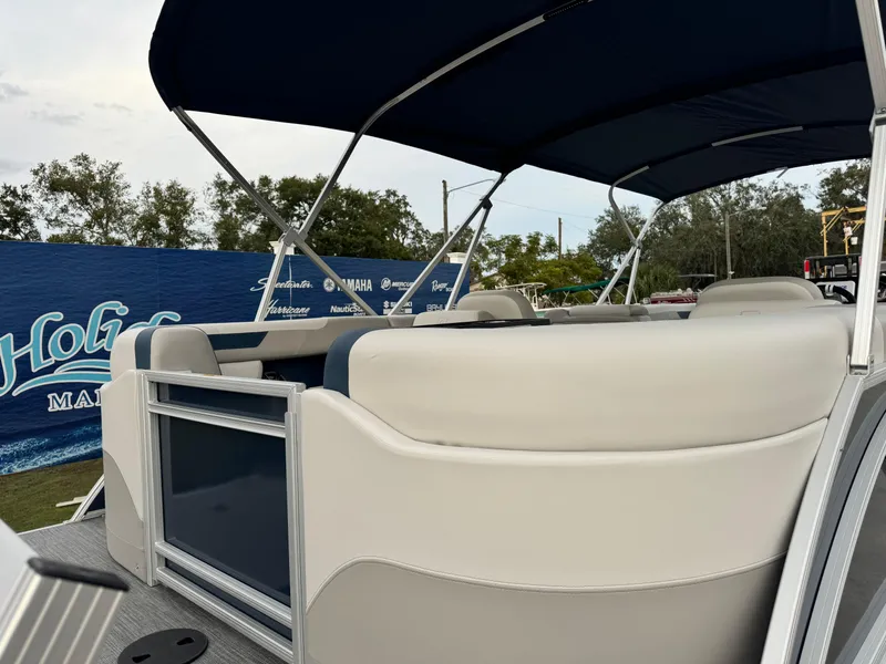 Slide: The Image of 2025 Sweetwater 2286 SB pontoon boat with canopy, featuring spacious seating and sleek design. - 11