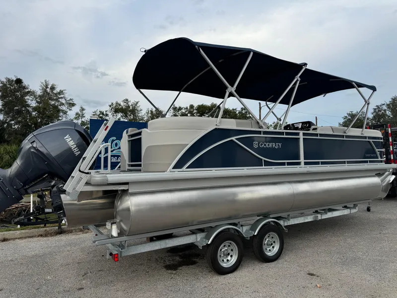 Slide: The Image of 2025 Sweetwater 2286 SB pontoon boat with canopy on trailer. - 2