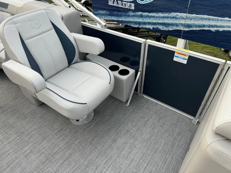 Slide: The Image of Luxurious seating on 2025 Sweetwater 2286 SB boat with cup holders and marine decor. - 6