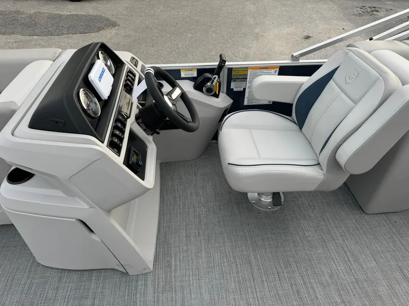 Slide: The Image of 2025 Sweetwater 2286 SB boat interior with steering console and captain's chair. - 7