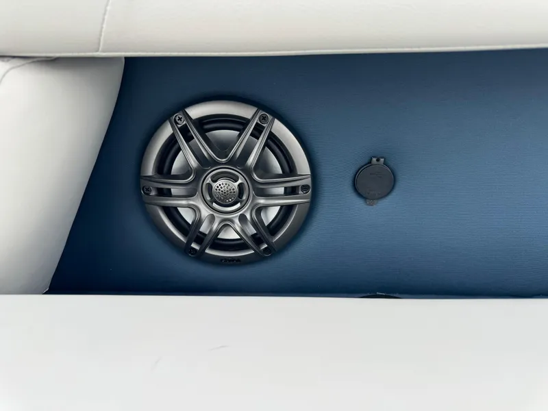 Slide: The Image of 2025 Sweetwater 2286 SB boat speaker and outlet on blue panel. - 8