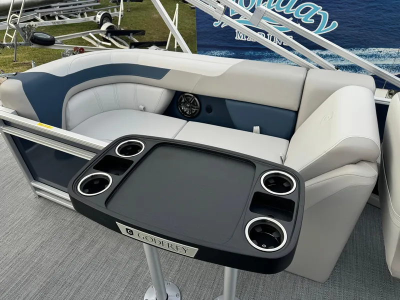 Slide: The Image of Sweetwater 2286 SB 2025 boat interior with seating and cup holder table. - 9