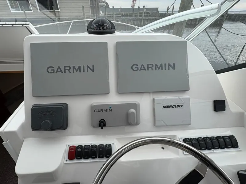 Slide: The Image of 2025 Albemarle 30 Express helm with Garmin and Mercury controls. - 10