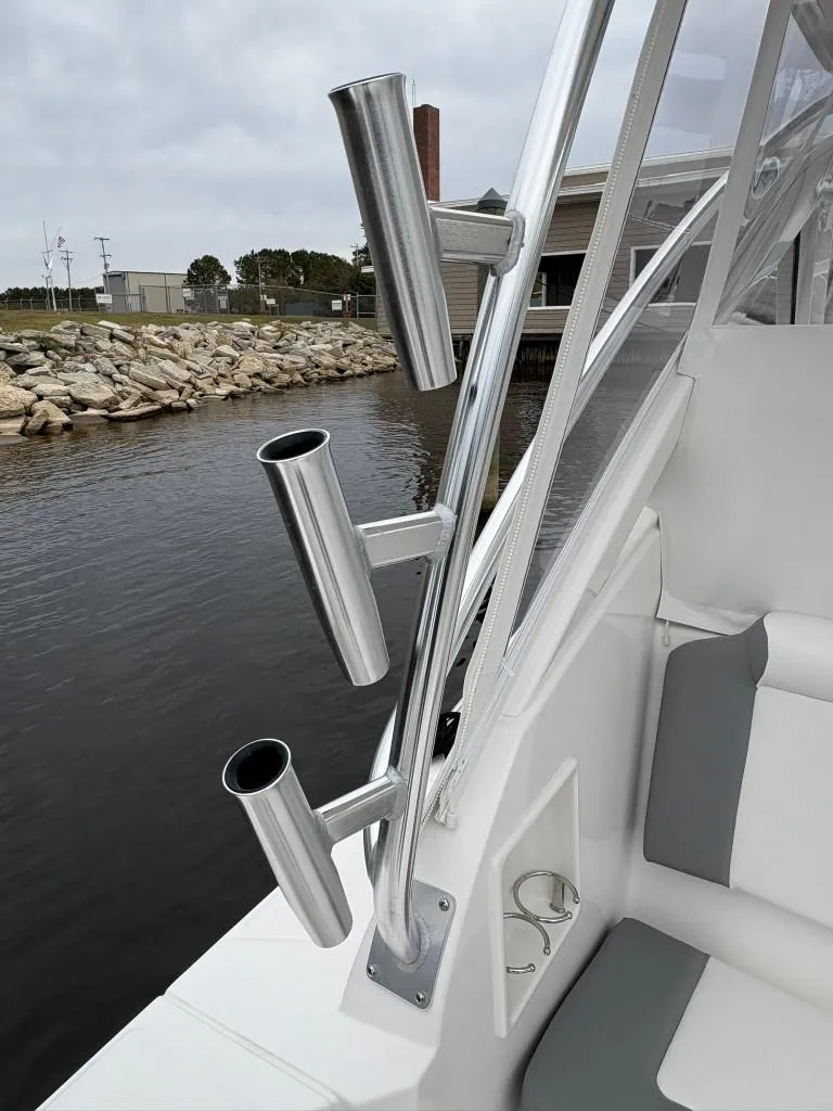 Slide: The Image of 2025 Albemarle 30 Express boat with rod holders by the water. - 12