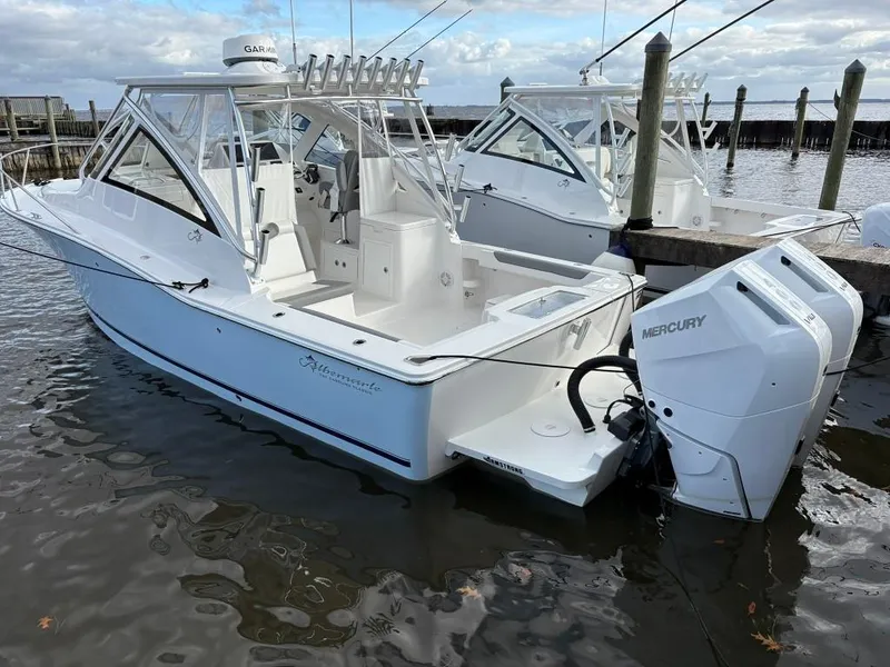 Slide: The Image of 2025 Albemarle 30 Express boat with twin Mercury engines docked in marina. - 4