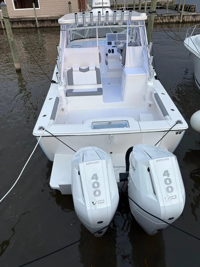 Slide: The Image of 2025 Albemarle 30 Express boat with twin 400 HP outboard engines docked in marina. - 5