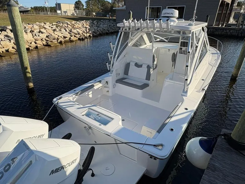 Slide: The Image of 2025 Albemarle 30 Express boat docked with twin Mercury engines. - 7