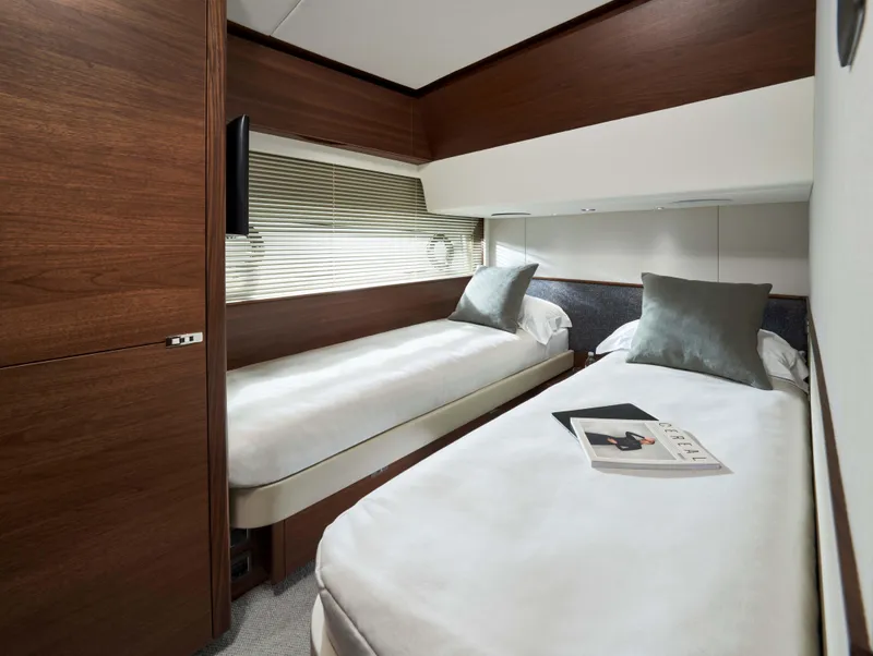 Slide: The Image of Luxurious twin cabin in 2025 Princess F65 yacht with modern decor and cozy bedding. - 11