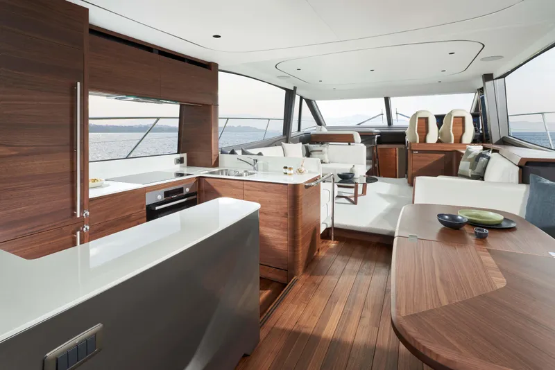 Slide: The Image of Luxurious interior of 2025 Princess F65 yacht with modern wood finishes and spacious seating. - 8