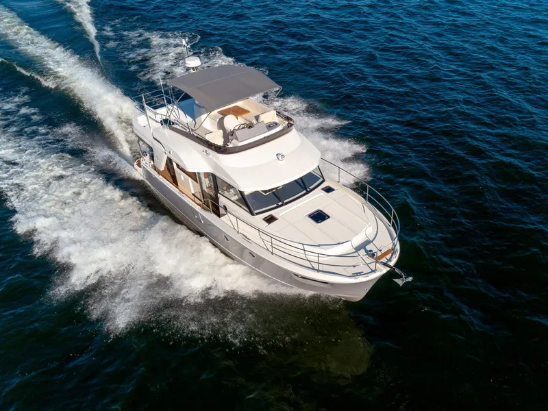 Slide: The Image of 2024 Beneteau Swift Trawler 41 cruising on open water, aerial view. - 10