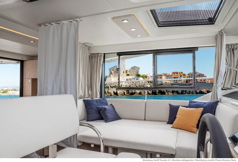 Slide: The Image of Interior of 2024 Beneteau Swift Trawler 41 with scenic ocean view. - 23