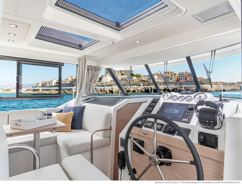 Slide: The Image of Interior of 2024 Beneteau Swift Trawler 41, featuring modern helm and seating area. - 40