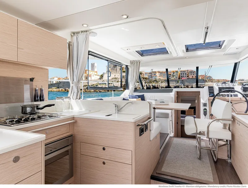Slide: The Image of Luxurious interior of 2024 Beneteau Swift Trawler 41 with modern kitchen and seating area. - 43