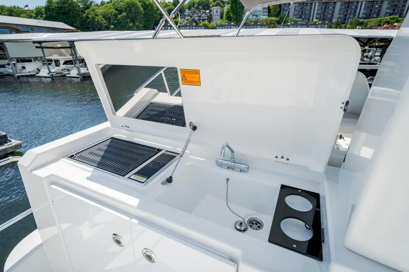 Slide: The Image of Outdoor kitchen on 2024 Beneteau Swift Trawler 41, featuring grill and sink. - 15