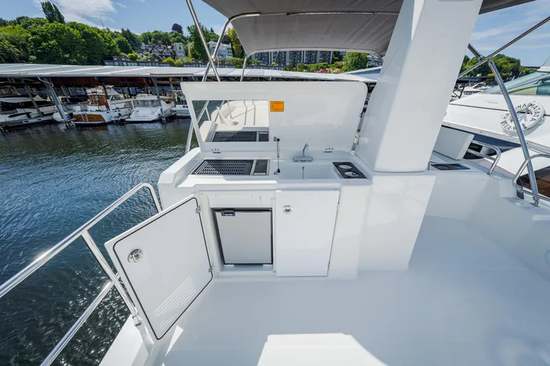 Slide: The Image of 2024 Beneteau Swift Trawler 41 outdoor kitchen with sink and grill on deck. - 17