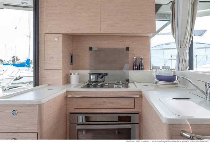 Slide: The Image of 2024 Beneteau Swift Trawler 41 kitchen with modern appliances and sleek design. - 22