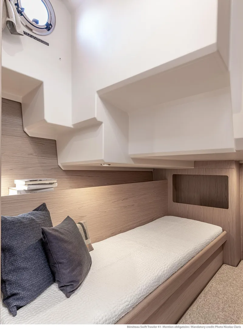 Slide: The Image of 2024 Beneteau Swift Trawler 41 cabin interior with cozy bed and modern design. - 33