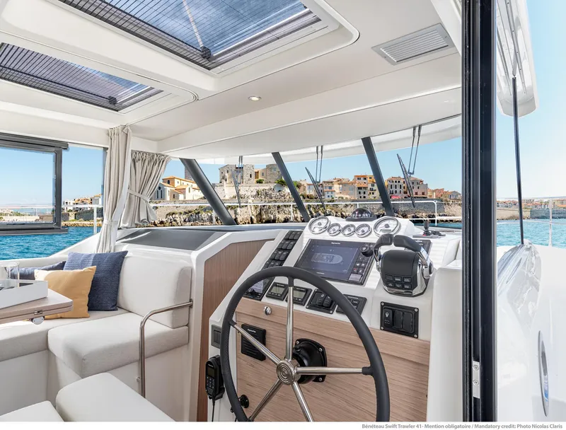 Slide: The Image of Interior of 2024 Beneteau Swift Trawler 41, featuring modern helm and seating area. - 39