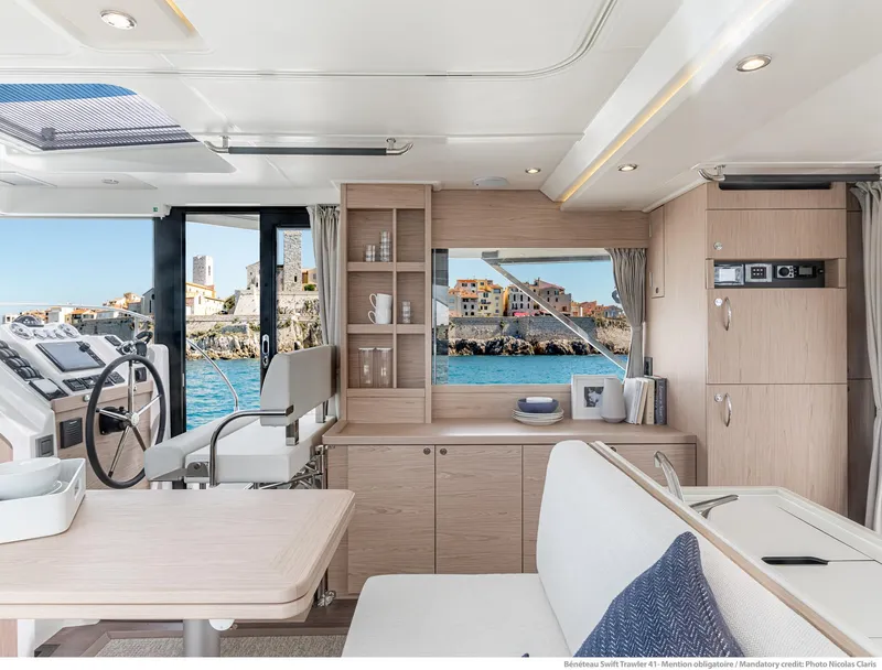 Slide: The Image of Interior of 2024 Beneteau Swift Trawler 41 with ocean view and modern furnishings. - 42
