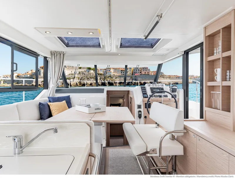 Slide: The Image of Luxurious interior of 2024 Beneteau Swift Trawler 41 with modern furnishings and scenic views. - 44