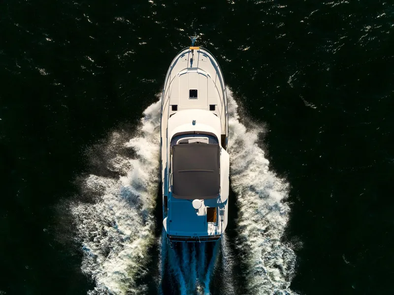 Slide: The Image of 2024 Beneteau Swift Trawler 41 cruising on open water, aerial view. - 7
