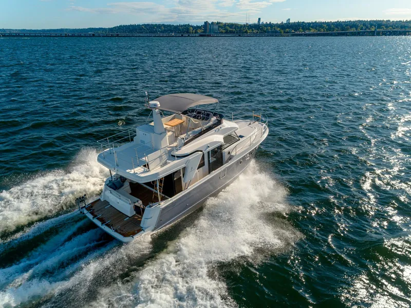 Slide: The Image of 2024 Beneteau Swift Trawler 41 cruising on open water, aerial view. - 8