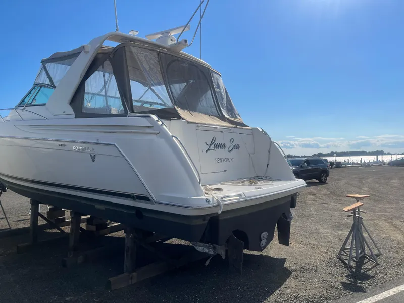 Slide: The Image of 1998 Formula 41PC yacht on dry dock under clear blue sky. - 11