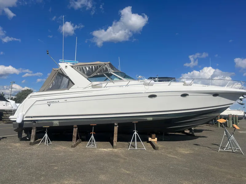 Slide: The Image of 1998 Formula 41PC yacht on stands, clear sky background. - 13
