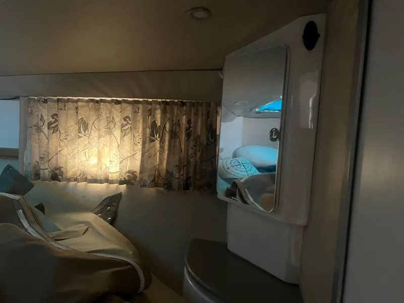 Slide: The Image of Interior cabin of a 1998 Formula 41PC boat with cozy lighting and floral curtains. - 8