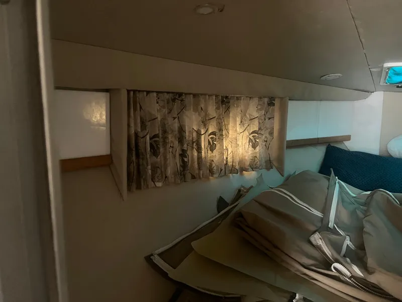 Slide: The Image of Interior of 1998 Formula 41PC boat with patterned curtains and cushions. - 9