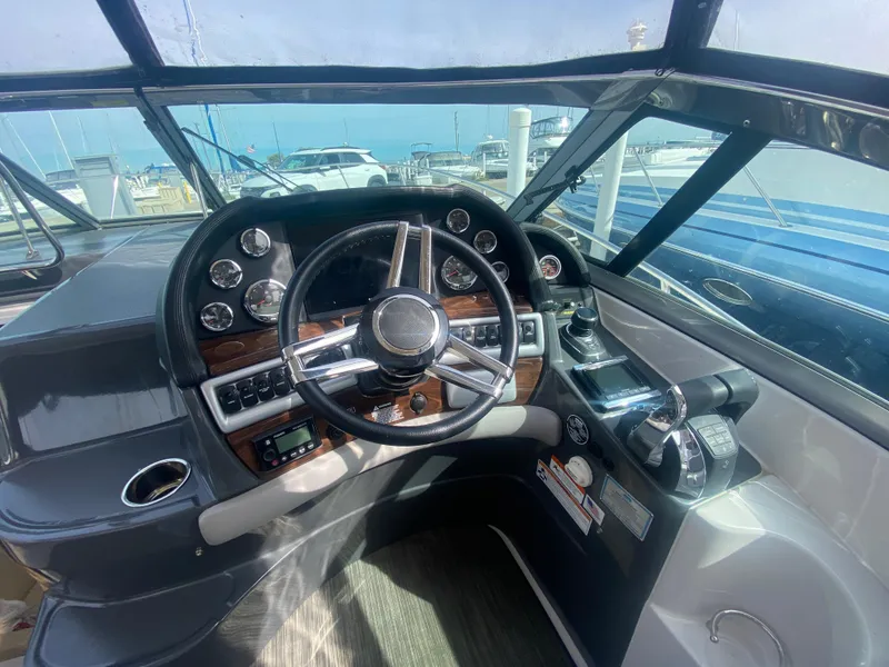 Slide: The Image of 2018 Four Winns 355 Vista helm with instruments and steering wheel. - 11