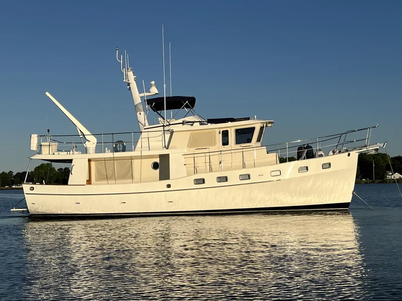 The Image of 2004 Kadey-Krogen Krogen North Sea yacht on calm water under clear sky. - 0