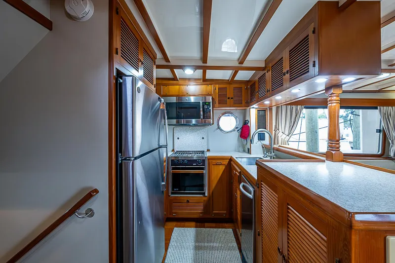 Slide: The Image of 2004 Kadey-Krogen Krogen North Sea yacht kitchen with wood cabinetry and stainless steel appliances. - 12