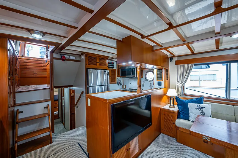 Slide: The Image of Luxurious 2004 Kadey-Krogen North Sea yacht interior with wood finishes and modern amenities. - 13