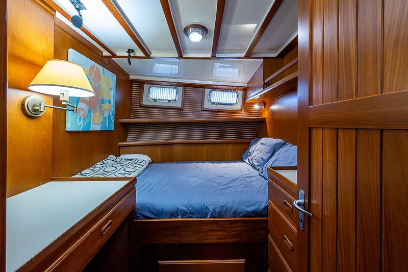 Slide: The Image of Luxurious 2004 Kadey-Krogen North Sea yacht cabin with wood paneling and cozy bed. - 15