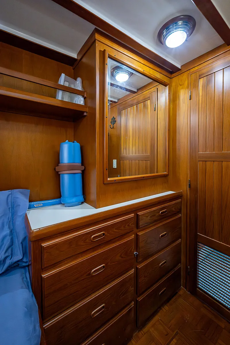 Slide: The Image of 2004 Kadey-Krogen Krogen North Sea cabin with wooden cabinetry and storage drawers. - 16