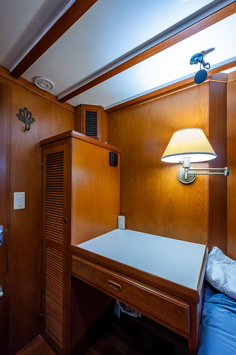 Slide: The Image of 2004 Kadey-Krogen Krogen North Sea cabin with wooden desk and wall lamp. - 17