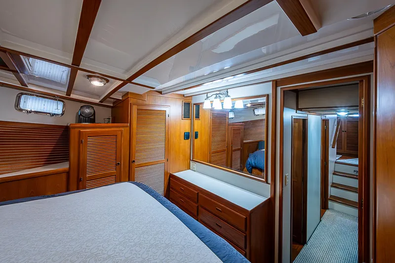 Slide: The Image of Luxurious 2004 Kadey-Krogen Krogen North Sea yacht bedroom with wooden cabinetry and elegant lighting. - 23